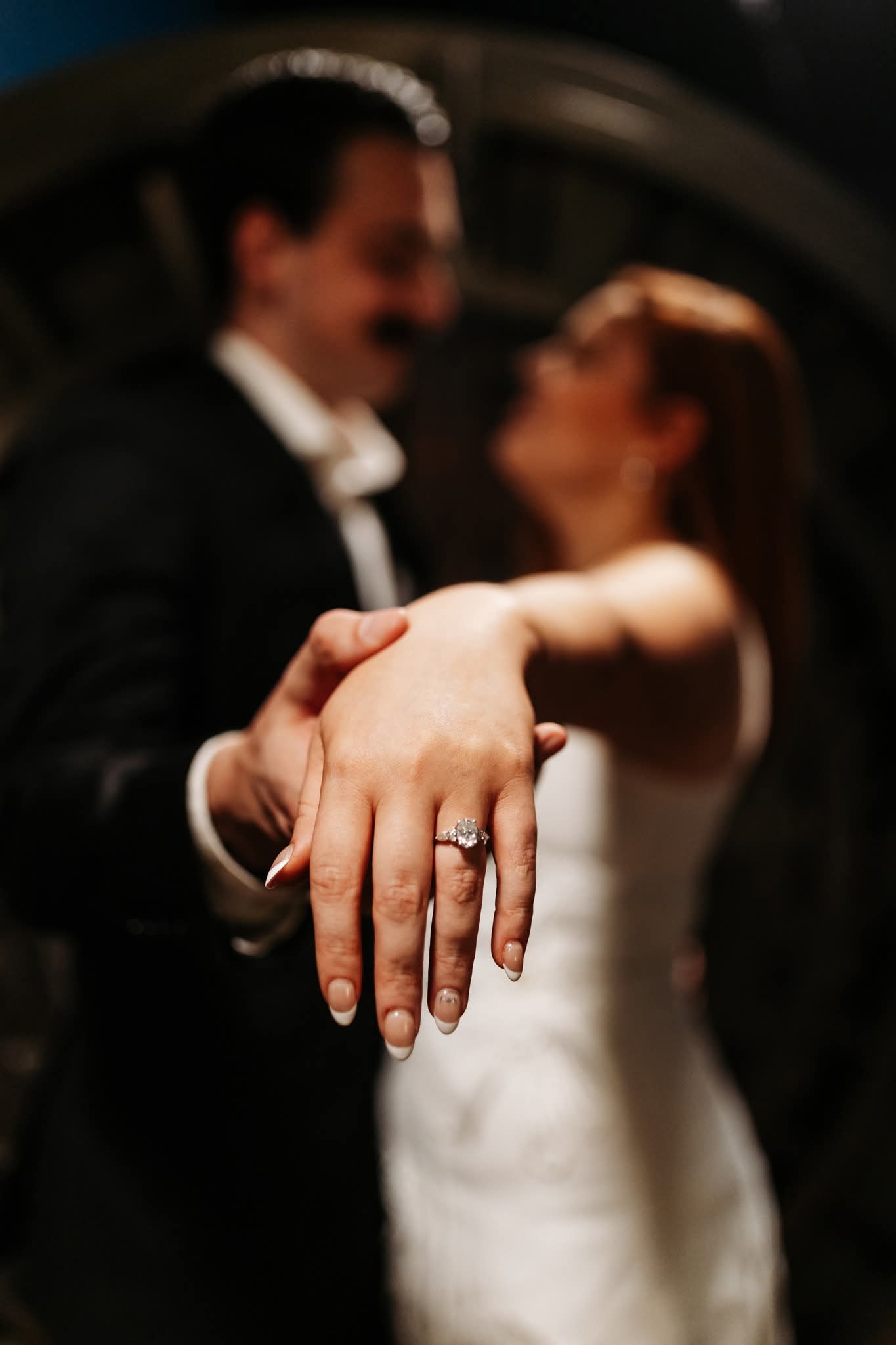 Kate showing her engagement ring while holding Jonah's hand